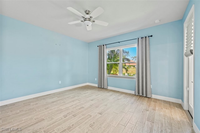 empty room with ceiling fan and light hardwood / wood-style floors