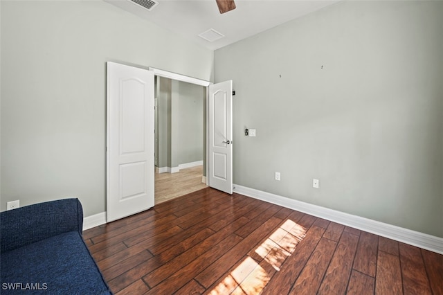 unfurnished bedroom featuring dark hardwood / wood-style floors and ceiling fan