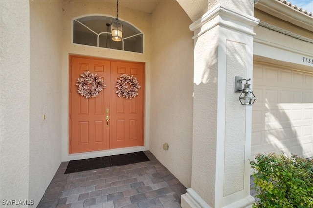 doorway to property with a garage