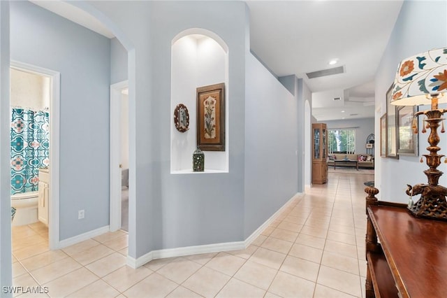 corridor featuring light tile patterned flooring