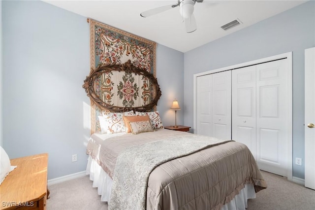 bedroom featuring light colored carpet, a closet, and ceiling fan