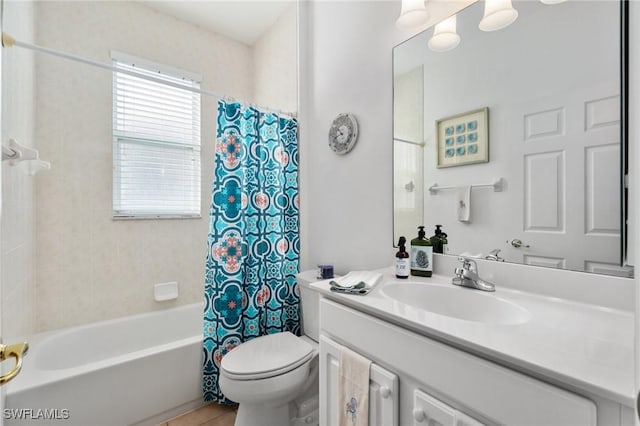 full bathroom with vanity, shower / bath combination with curtain, and toilet