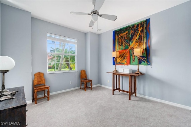 living area with carpet flooring and ceiling fan