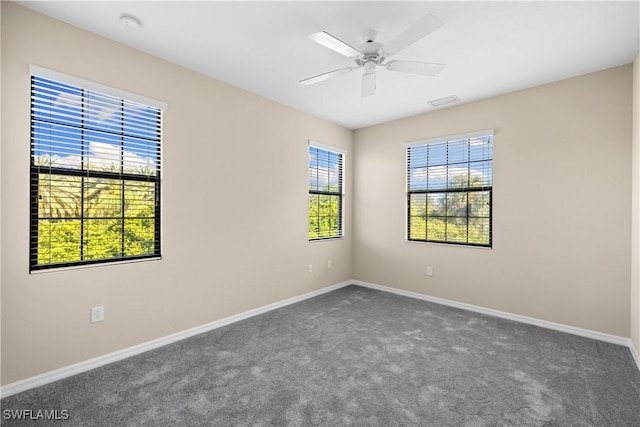 empty room with ceiling fan and carpet flooring