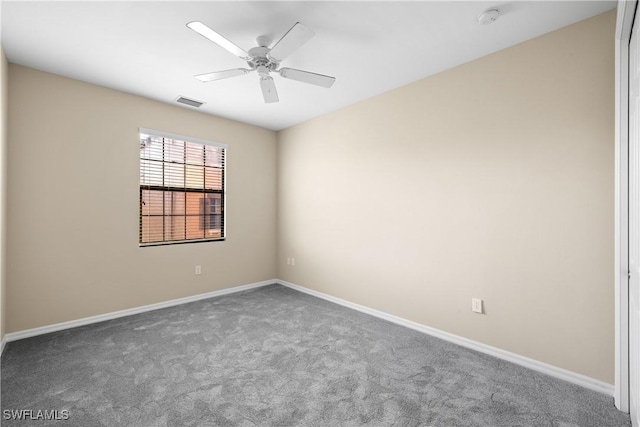 carpeted spare room with ceiling fan