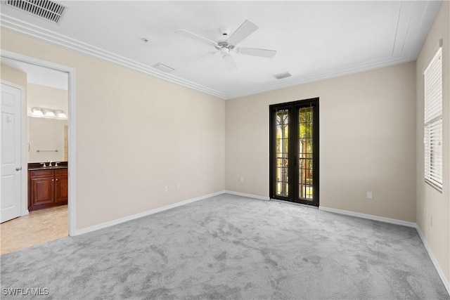 carpeted spare room featuring sink, ceiling fan, and french doors