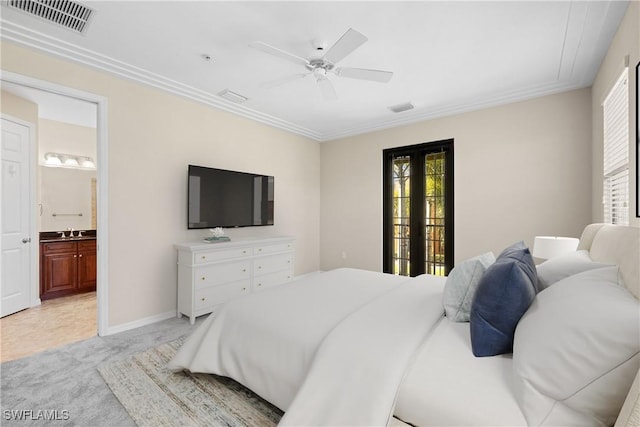 carpeted bedroom featuring sink, connected bathroom, ceiling fan, and french doors