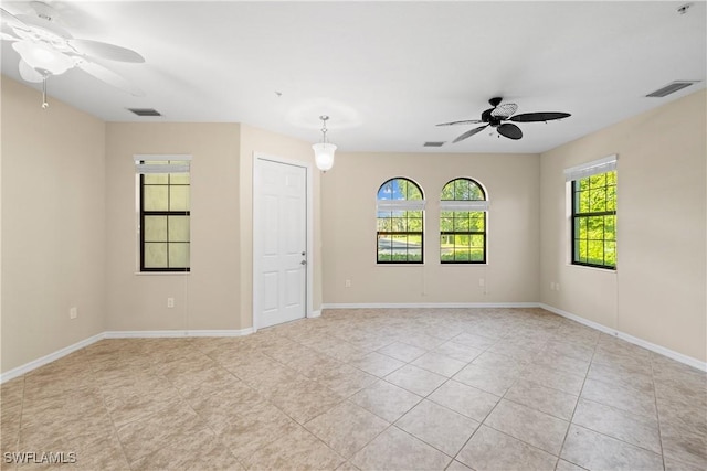 empty room with light tile patterned floors and ceiling fan