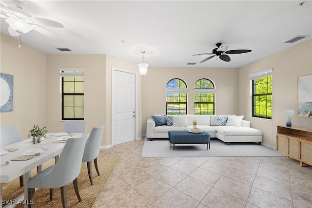 living room featuring light tile patterned floors and ceiling fan