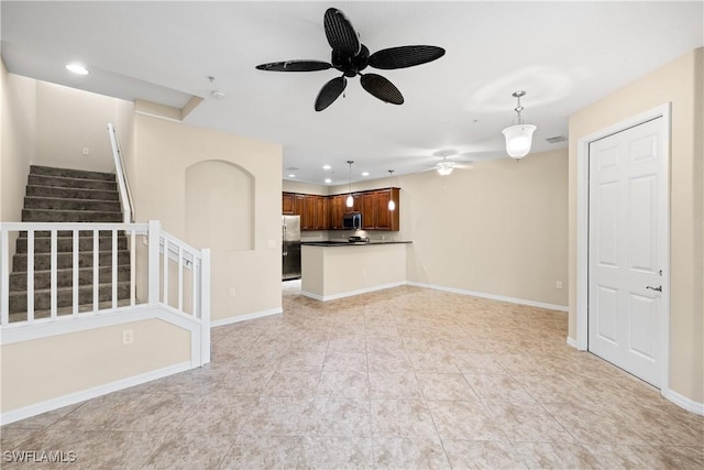 unfurnished living room with ceiling fan