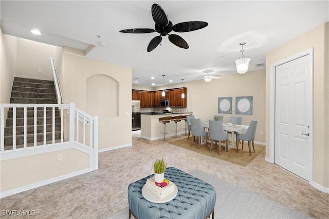 tiled living room with ceiling fan