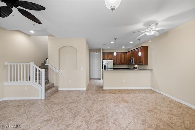 kitchen with ceiling fan, hanging light fixtures, kitchen peninsula, and appliances with stainless steel finishes