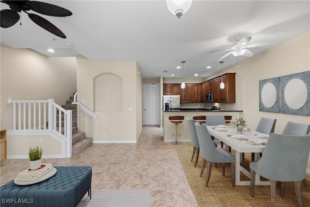 dining area with light tile patterned flooring and ceiling fan