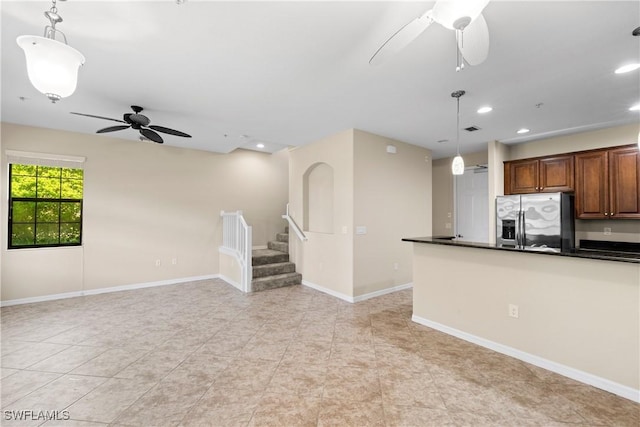 kitchen featuring decorative light fixtures, stainless steel refrigerator with ice dispenser, and ceiling fan