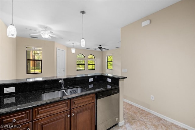 kitchen with dishwasher, dark stone counters, sink, hanging light fixtures, and light tile patterned flooring