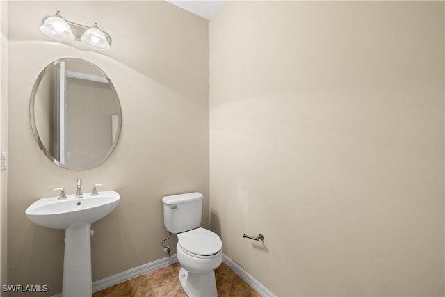 bathroom featuring toilet and tile patterned flooring