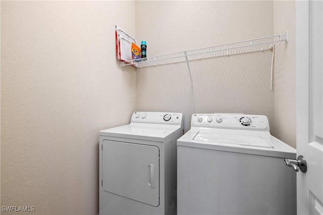 laundry room featuring separate washer and dryer