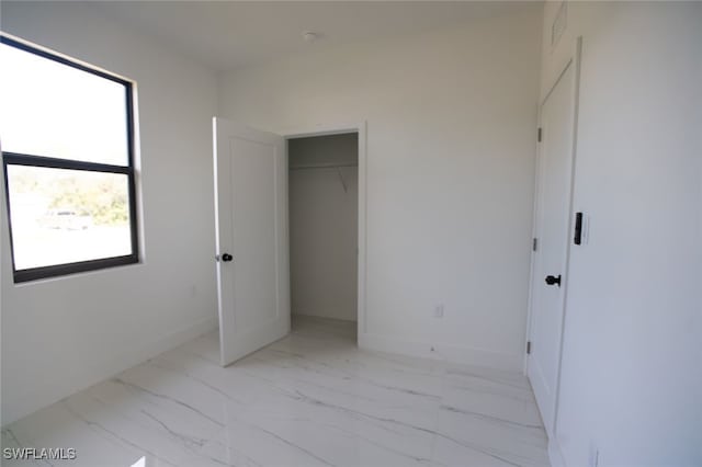 unfurnished bedroom with a closet