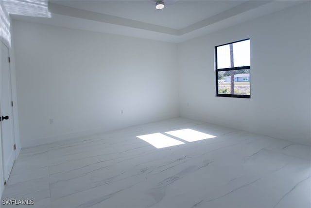 empty room with a raised ceiling