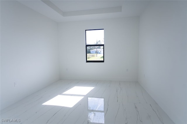 empty room featuring a tray ceiling