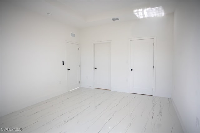 unfurnished bedroom with multiple closets