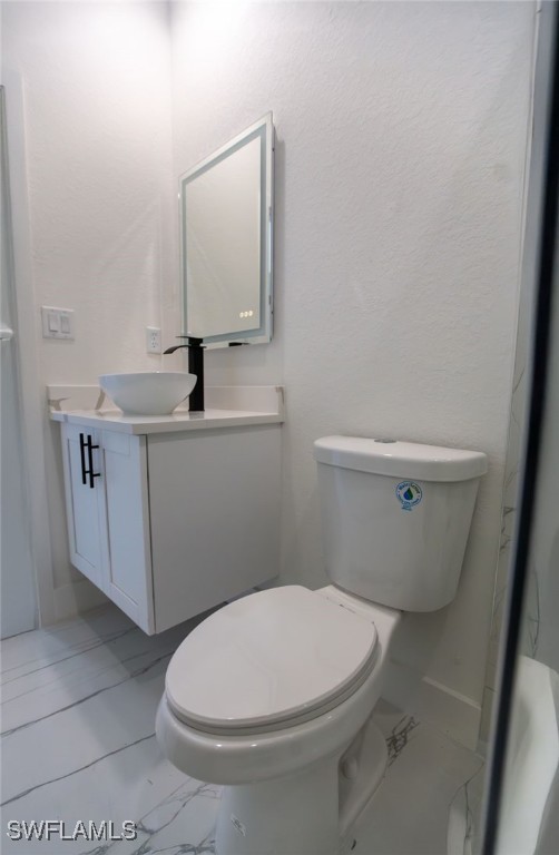 bathroom featuring vanity and toilet