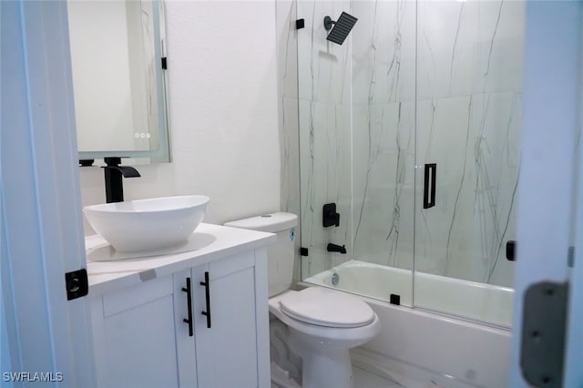 full bathroom with vanity, combined bath / shower with glass door, and toilet