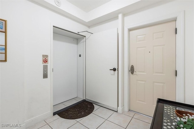 interior space featuring light tile patterned floors and elevator