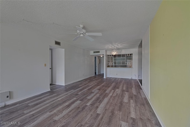 unfurnished living room with ceiling fan with notable chandelier, hardwood / wood-style floors, and a textured ceiling