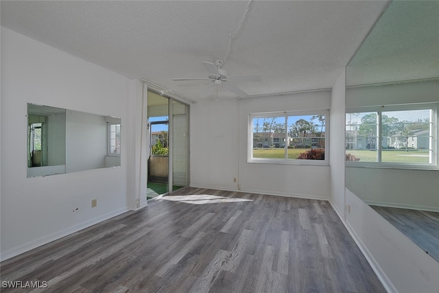 spare room with hardwood / wood-style flooring, a textured ceiling, and ceiling fan