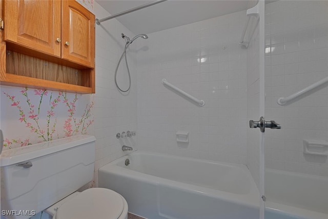 bathroom featuring tiled shower / bath combo and toilet