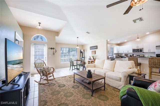 tiled living room with vaulted ceiling and ceiling fan