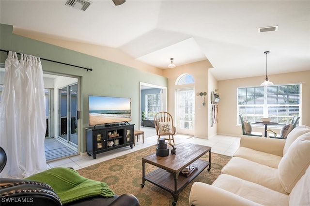 living room with vaulted ceiling and light tile patterned flooring