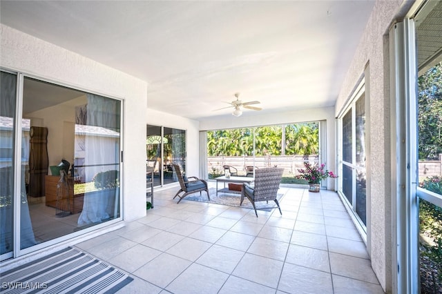 sunroom / solarium featuring ceiling fan