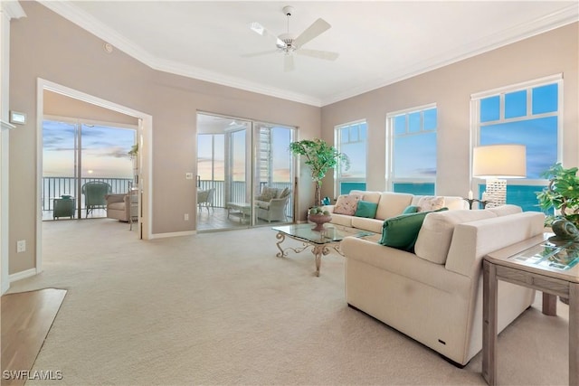 living room with ceiling fan, light colored carpet, ornamental molding, and a water view