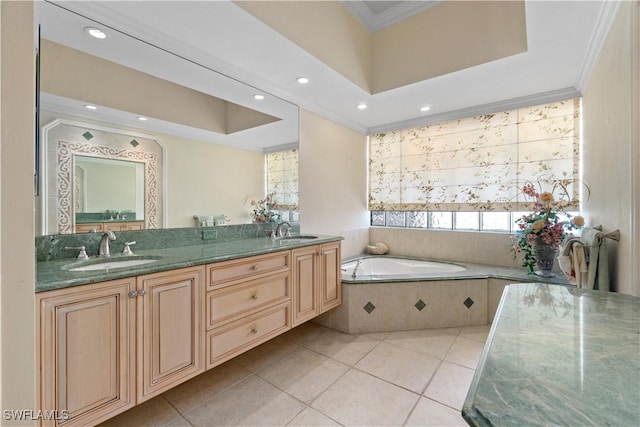 bathroom with tile patterned flooring, vanity, a relaxing tiled tub, and ornamental molding