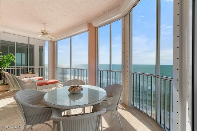 sunroom / solarium featuring a water view