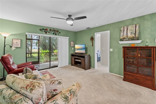 carpeted living room with a ceiling fan, visible vents, and baseboards