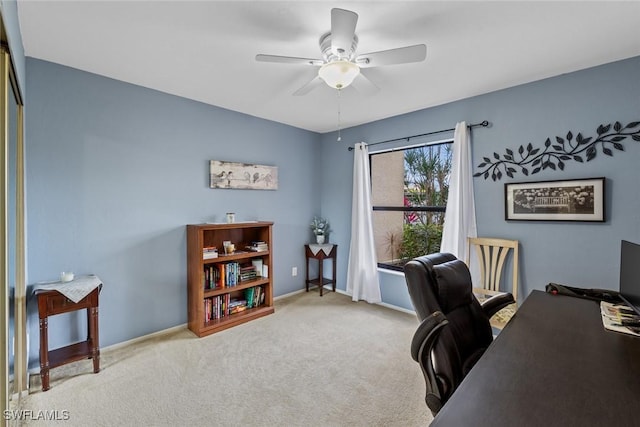 home office featuring light carpet and ceiling fan