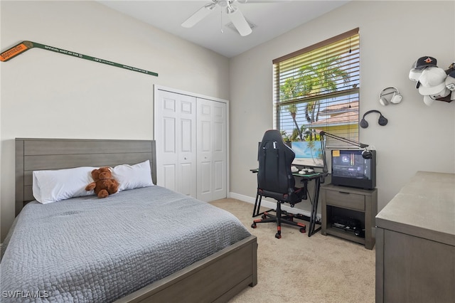 bedroom with ceiling fan, a closet, and light carpet