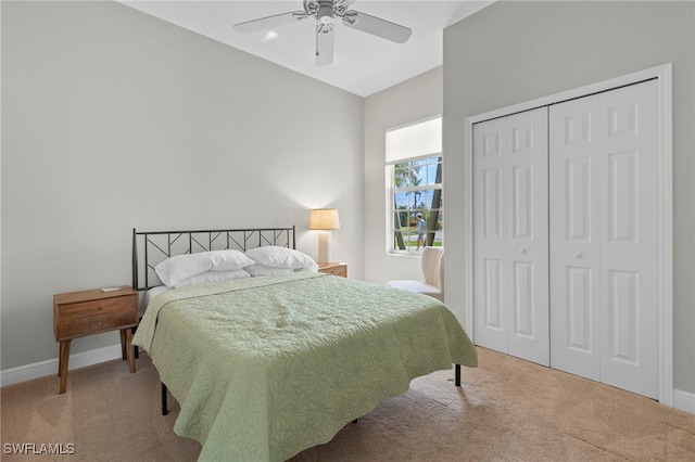 bedroom featuring ceiling fan, light colored carpet, and a closet