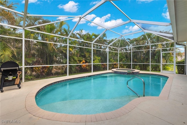 view of pool featuring a lanai, a patio area, and an in ground hot tub