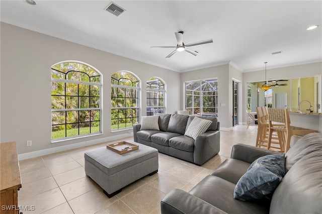 tiled living room with ceiling fan and ornamental molding