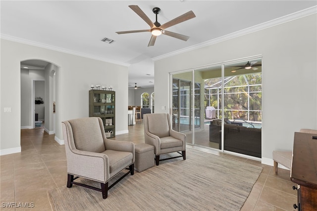 tiled living room featuring ceiling fan, plenty of natural light, and ornamental molding