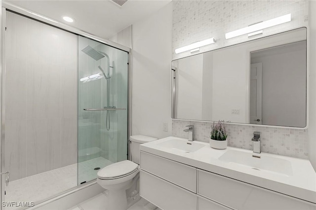 bathroom featuring toilet, walk in shower, tasteful backsplash, and vanity