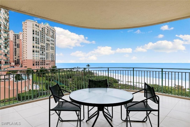 balcony with a beach view and a water view