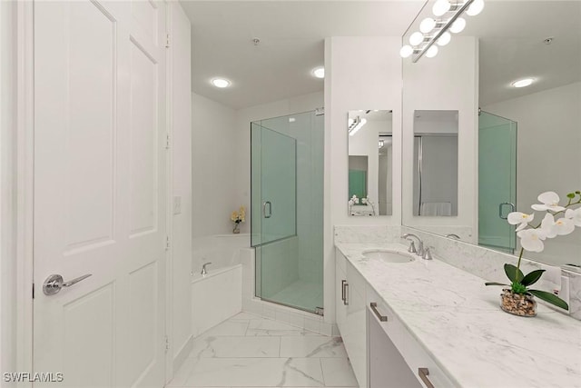 bathroom featuring vanity and separate shower and tub