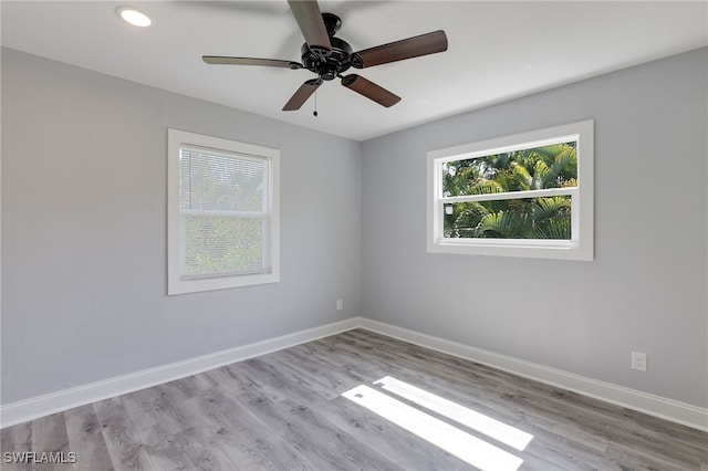 spare room with ceiling fan and light hardwood / wood-style flooring