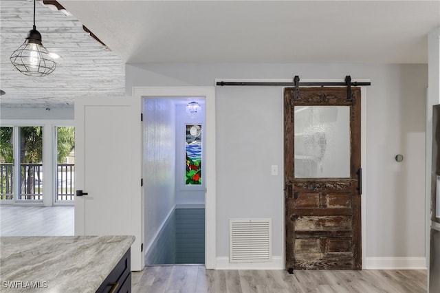 interior space featuring a barn door and light wood-type flooring