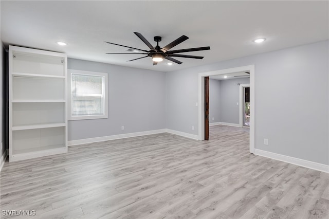 spare room with ceiling fan and light wood-type flooring